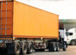 A truck transporting a shipping container for conversion showcases its application in the automotive industry.