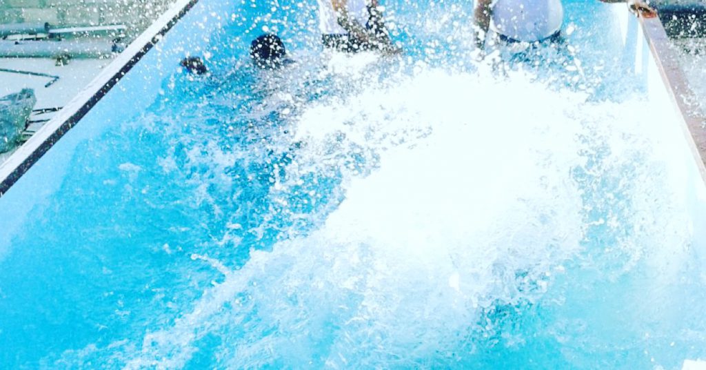 People Playing in the Shipping Container Pool