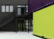 View of stacked shipping containers illustrates container conversion into classroom or education spaces.