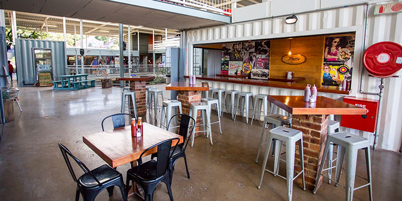 The-Most-Creative-Repurposing-Ideas-for-Shipping-Containers A view of the interior of a shopping complex made out of used shipping containers.