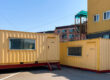 A yellow shipping container representing the beginning of its journey in the shipping lifecycle.