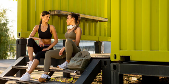 shipping-container-gym Two women chatting outside the shipping container gym post workout.