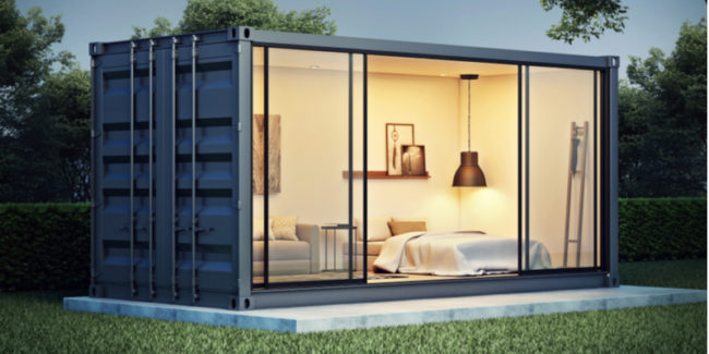 stiuae A 3D illustration of a container home displaying a bedroom setup with a comfy bed,sofa, lighting etc in a lush green environment